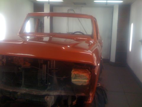 1978 Ford Bronco - 1978 Ford Bronco cab undergoing paint work in a booth.