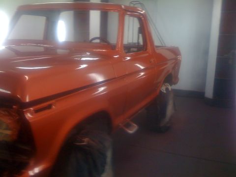 1978 Ford Bronco - This orange pickup truck is shown from a 3/4 front angle, with the registry labeling it as a 1978 Ford Bronco.