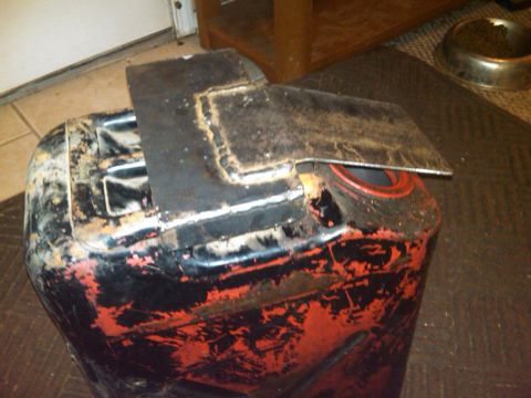 1995 Ford F-150 - A jerry can with a custom metal bracket welded to its top surface.