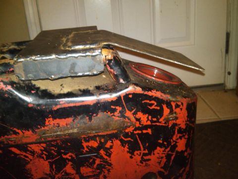 1995 Ford F-150 - A custom metal bracket is welded onto the top of a weathered jerry can, showing signs of rust and wear.