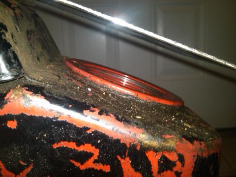 1995 Ford F-150 - Detail of the cap area on a weathered jerry can, showing the threaded opening.