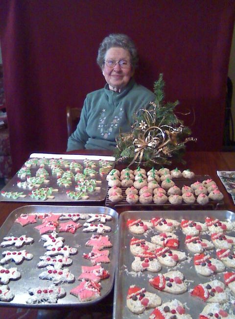 2006 Ford E350 - A woman proudly displays a large assortment of homemade Christmas cookies, ready for the holidays.