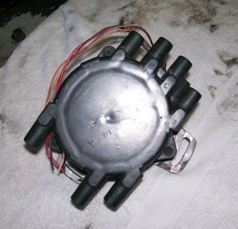 1995 Ford Probe - A distributor cap with multiple wires and numbered ports is shown.
