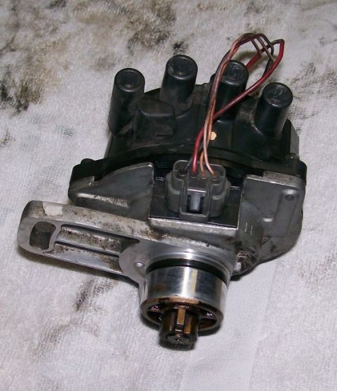 1995 Ford Probe - Close-up of a car's distributor cap and rotor assembly, showing electrical connections.