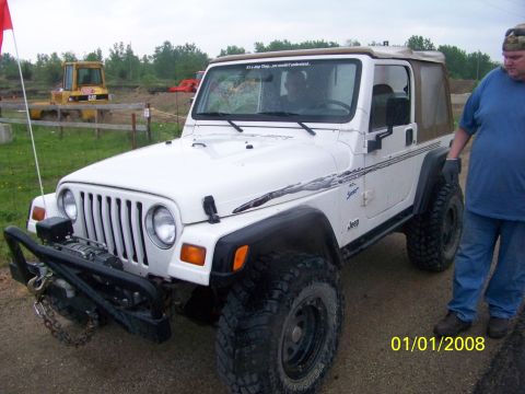 1989 Ford Bronco - White Jeep Wrangler with aftermarket bumper and winch, dated 01/01/2008.