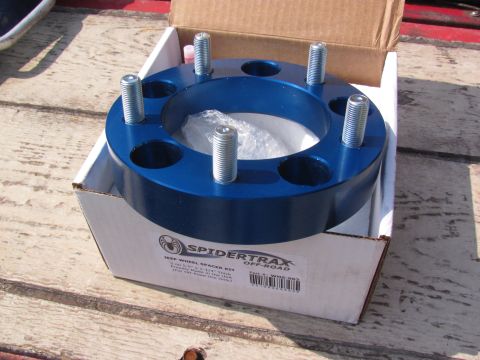 1995 Ford Bronco - A blue wheel spacer kit is shown in its packaging, with text indicating it is for off-road use.
