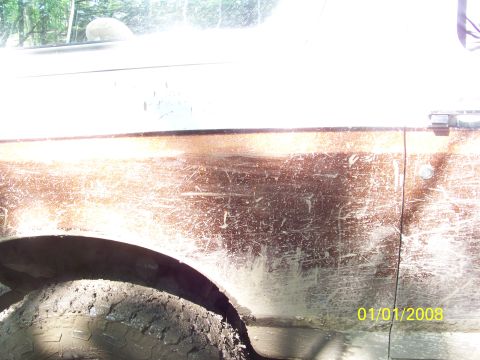1989 Ford Bronco - Mud-covered side panel of a vehicle, with a visible date stamp of 01/01/2008.