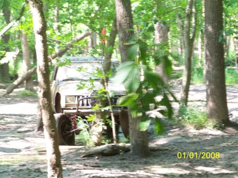 1989 Ford Bronco - Off-road vehicle navigating a muddy trail through a forest on January 1, 2008.