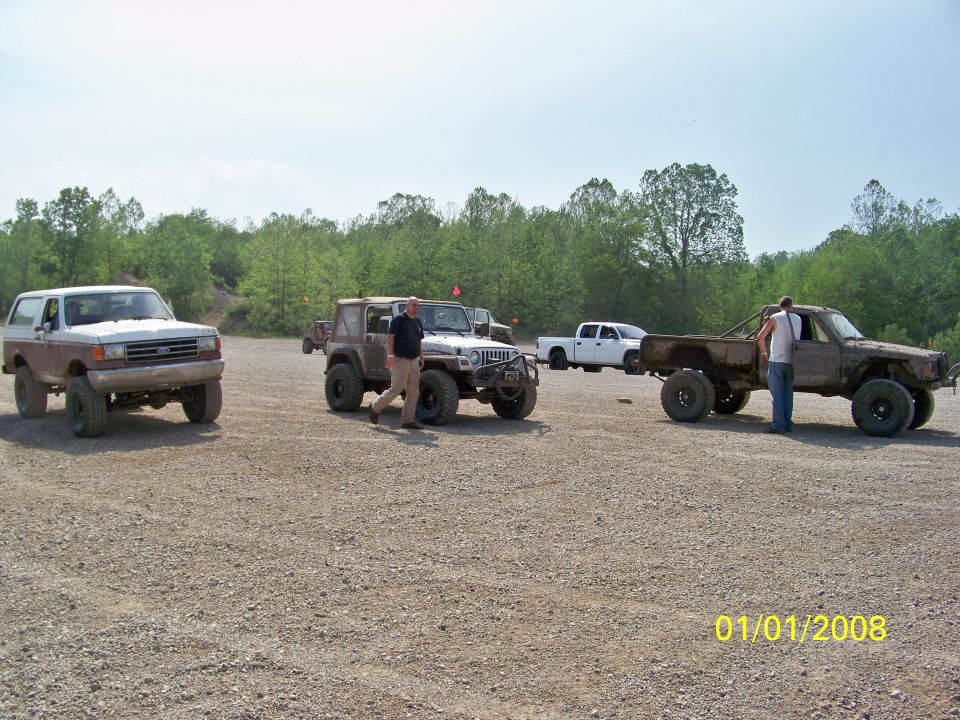 White and brown 1989 Ford Bronco, 3/4 front view, lifted suspension