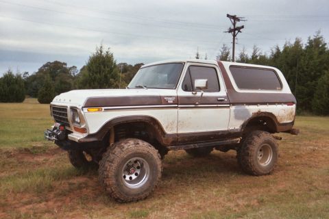 1978 Ford Bronco - This lifted 1978 Ford Bronco is shown in a three-quarter front view, parked outdoors on a cloudy day.