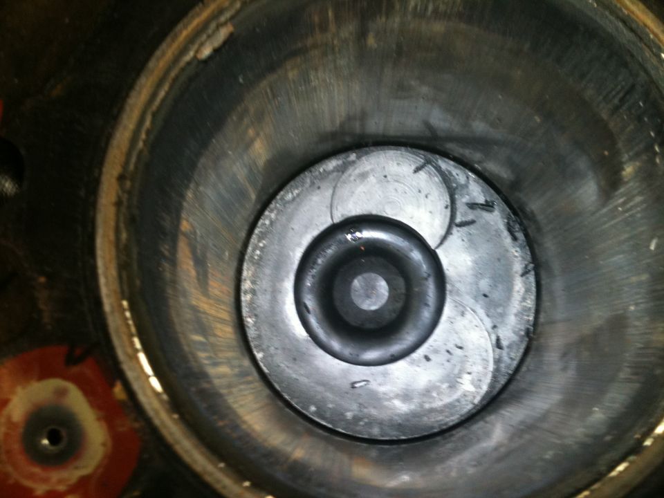 Close-up of an engine cylinder bore and valve detail with machining marks
