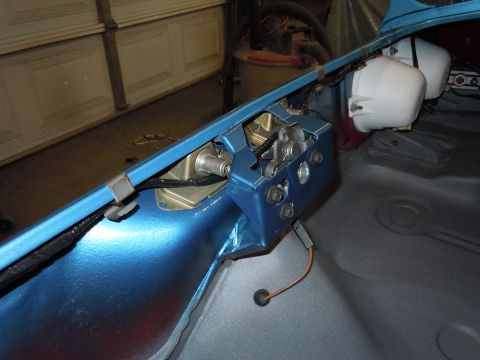 1972 Chevrolet Camaro - Close-up of a blue painted car interior component with visible wiring and two white cylindrical parts attached.