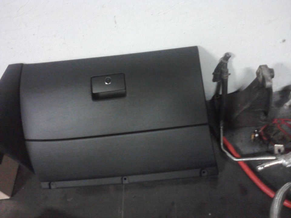 Black glove box door with latch