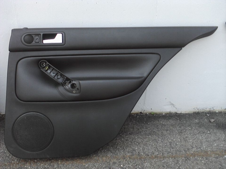 Black car door panel with speaker and manual window crank