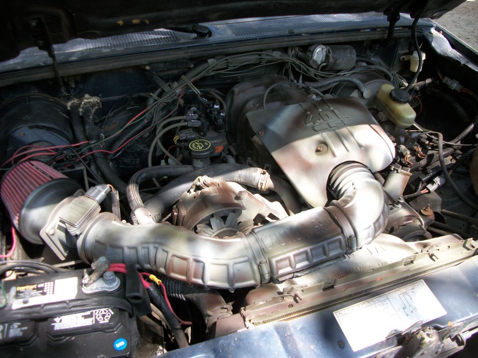 engine bay with air intake and battery visible