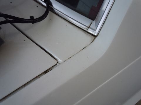 2001 Ford Crown Victoria - Detail shot of a car's body panel seam, showing wear and a loose wire.