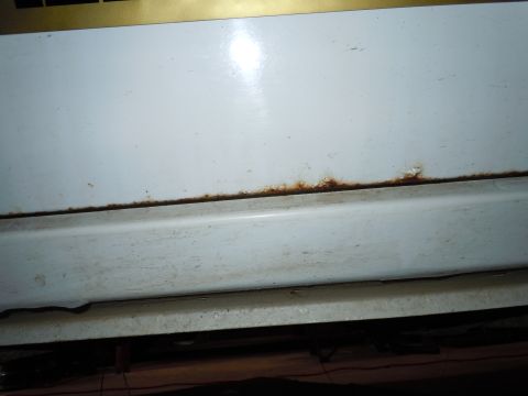 2001 Ford Crown Victoria - Rust is visible along the seam of a white panel, indicating potential corrosion.