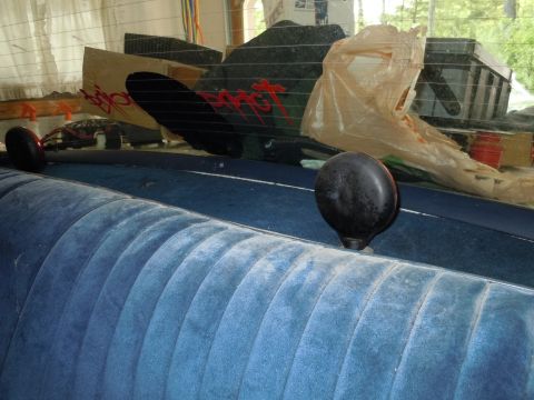 2001 Ford Crown Victoria - Interior view of a car's rear seat and deck, with items obscuring the rear window.