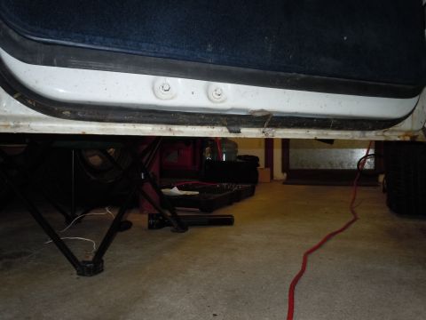 2001 Ford Crown Victoria - Close-up view of a car's door sill and the underside of the vehicle.