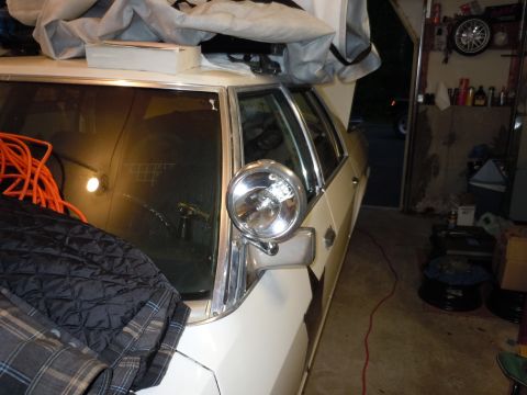 2001 Ford Crown Victoria - A white 2001 Ford Crown Victoria police car is parked in a garage, partially covered.