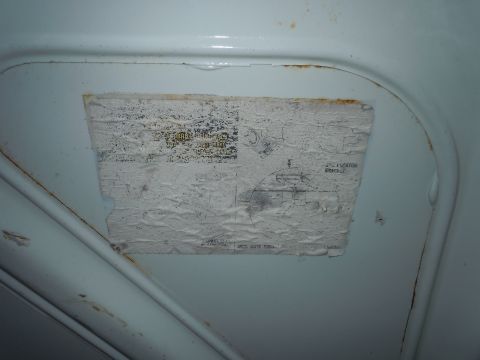 2001 Ford Crown Victoria - Close-up of a damaged underhood sticker with a diagram and some text visible.
