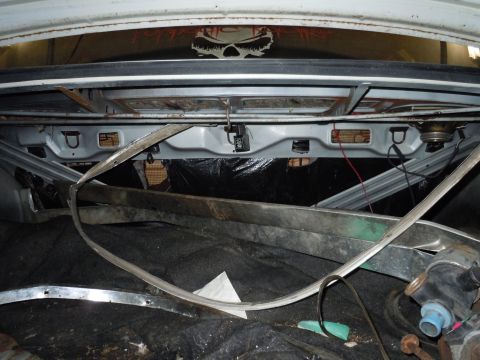 2001 Ford Crown Victoria - The interior of a car trunk is visible, with various parts and debris scattered around.