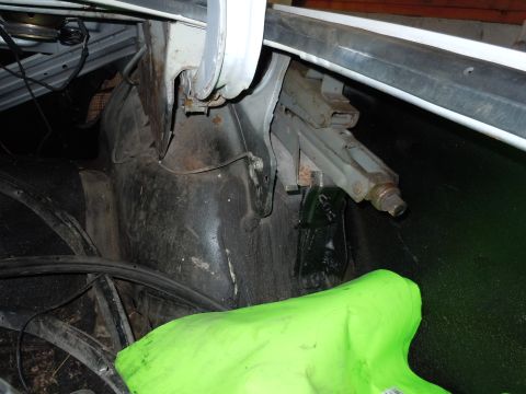2001 Ford Crown Victoria - The image shows the interior of a vehicle's trunk, including a jack and a bright green cover. No specific vehicle year is identifiable.
