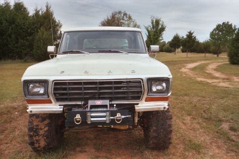1978 Ford Bronco - Front view of a white 1978 Ford Bronco equipped with a winch, parked outdoors.