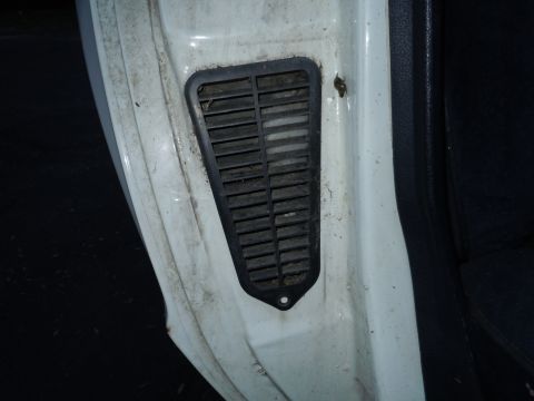 2001 Ford Crown Victoria - A dirty black vent is visible on the interior door frame of a white vehicle.