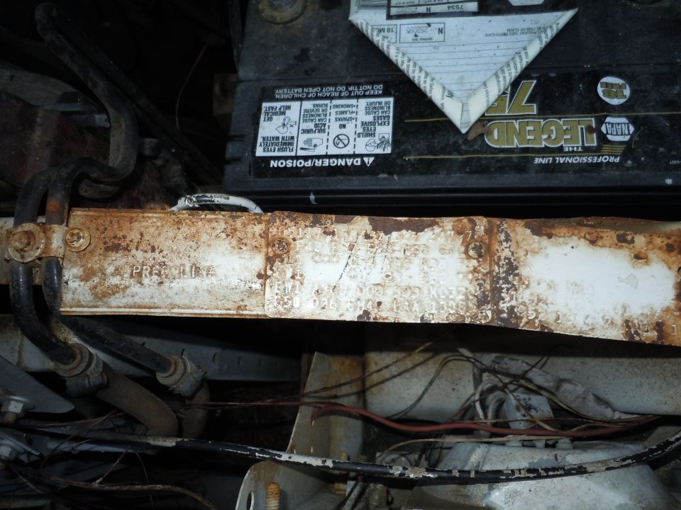 NAPA Legend 75 battery and rusty metal frame with visible text