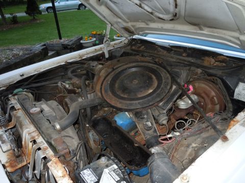 2001 Ford Crown Victoria - The engine compartment of a vehicle, showing various components and wiring.