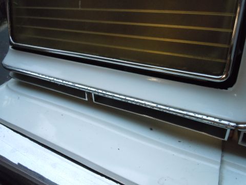 2001 Ford Crown Victoria - Detail of a vehicle's front grille, showing horizontal slats and chrome accents.