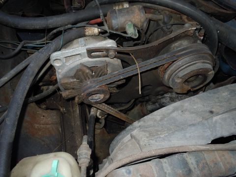 2001 Ford Crown Victoria - Close-up view of engine components, including the alternator and drive belts.