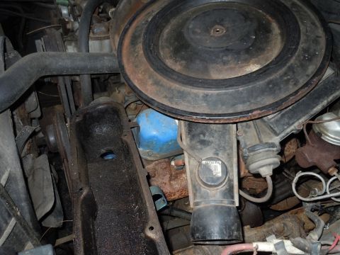 2001 Ford Crown Victoria - Close-up view of an engine bay, showing the air cleaner assembly, various hoses, and a blue oil filter.