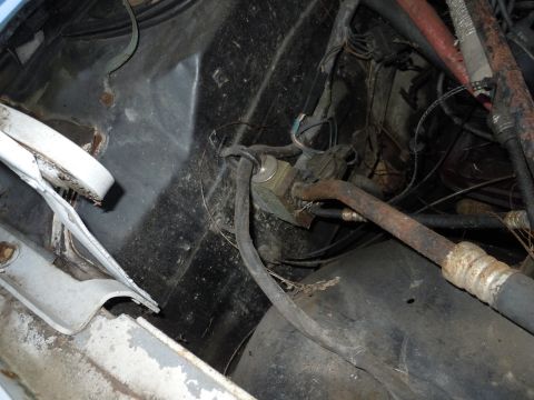 2001 Ford Crown Victoria - Close-up view of engine bay components, including hoses and wiring, with some white trim on the left.