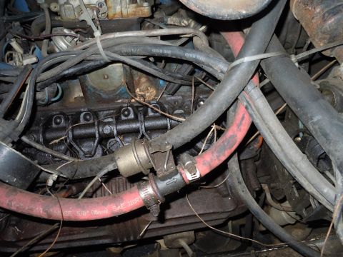 2001 Ford Crown Victoria - The engine bay is filled with various hoses and wiring, showing signs of wear and tear.