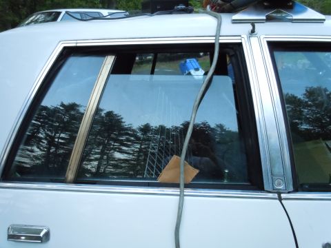 2001 Ford Crown Victoria - A white sedan's side profile is shown, with a second vehicle partially visible behind it.