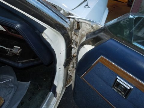 2001 Ford Crown Victoria - View of the interior door frame and panel, showing damage and a second vehicle in the background.