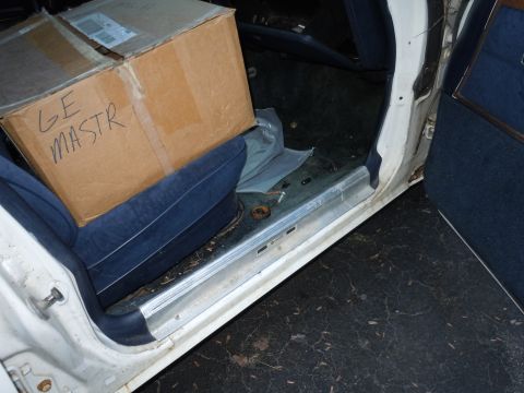 2001 Ford Crown Victoria - Interior view of a car's passenger side, showing boxes on the seat and door panel.