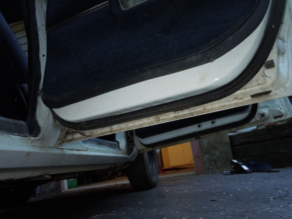 Interior door frame and dark blue carpet of a vehicle