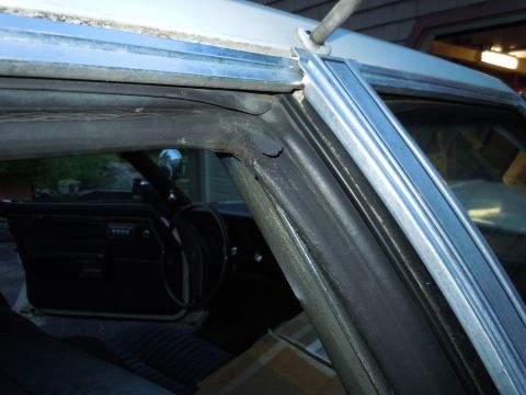 2001 Ford Crown Victoria - Close-up view of a car's interior, focusing on the window frame and door panel details.