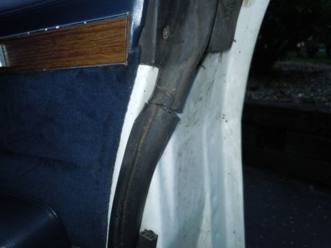 2001 Ford Crown Victoria - Close-up of the interior door seal on a 2001 Ford Crown Victoria, showing wear and tear.
