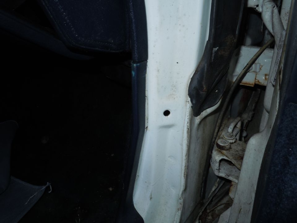 2001 Ford Crown Victoria interior door jamb with visible hinges and wiring