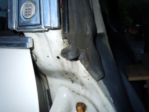 2001 Ford Crown Victoria - Detail of the door jamb area, showing some wear and tear on the rubber seal and surrounding metal.