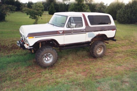 1978 Ford Bronco - This 1978 Ford Bronco has a lifted suspension and off-road tires, with some rust visible on the rear fender.