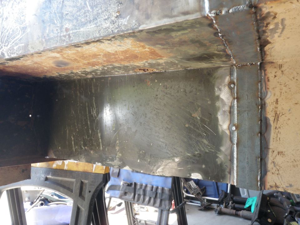 Close-up of welded metal frame with rust and scratches