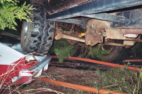 1978 Ford Bronco - The underside of a vehicle is shown, with its tire resting on another vehicle.