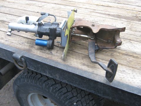 1978 Ford Bronco - A brake pedal assembly, including the master cylinder, is shown resting on a wooden surface.