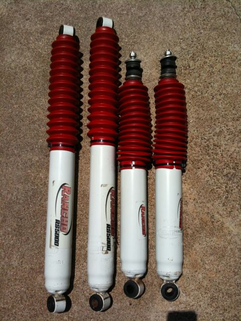 1996 Ford Bronco - Four Rancho RS5000 shock absorbers are laid out on a textured surface.