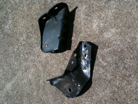 1996 Ford Bronco - Two black metal brackets are shown against a concrete background.